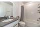 Modern bathroom features a vanity with a gray countertop and a tiled shower-tub combo at 5531 Keaton Springs Dr, Lakeland, FL 33811