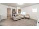 Cozy bedroom featuring gray carpet, white walls, comfortable white sofa, and an artful display at 5531 Keaton Springs Dr, Lakeland, FL 33811