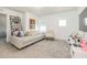 Cozy bedroom featuring gray carpet, white walls, comfortable white sofa, and an artful display at 5531 Keaton Springs Dr, Lakeland, FL 33811
