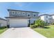 Charming two-story home with a large two car garage, well-manicured lawn and beautiful landscaping at 5531 Keaton Springs Dr, Lakeland, FL 33811
