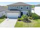 Two-story home with a well-manicured lawn, a two-car garage, and a gray exterior at 5531 Keaton Springs Dr, Lakeland, FL 33811