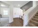 Bright foyer with hardwood floors, staircase, and decorative table at 5531 Keaton Springs Dr, Lakeland, FL 33811