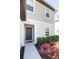 Inviting front entrance with a gray door, white trim, and colorful landscaping at 5531 Keaton Springs Dr, Lakeland, FL 33811