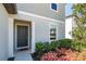 Inviting front entrance featuring a gray door and manicured landscaping with pink flowers at 5531 Keaton Springs Dr, Lakeland, FL 33811