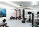 Garage equipped as a home gym, complete with weights, machines, and mirrored wall at 5531 Keaton Springs Dr, Lakeland, FL 33811