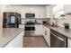 This kitchen features stainless steel appliances, gray countertops, and white cabinets at 5531 Keaton Springs Dr, Lakeland, FL 33811