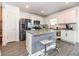 Bright kitchen featuring stainless steel appliances, gray countertops, and a cozy breakfast bar at 5531 Keaton Springs Dr, Lakeland, FL 33811