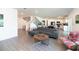 Spacious living room with gray sofa, wooden floors, and open concept to kitchen at 5531 Keaton Springs Dr, Lakeland, FL 33811