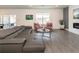 Comfortable living room features gray sofa, modern fireplace, and colorful accent chairs at 5531 Keaton Springs Dr, Lakeland, FL 33811