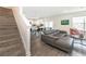 Spacious living room with gray sofa and open layout into the kitchen and dining area at 5531 Keaton Springs Dr, Lakeland, FL 33811