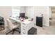 Home office with white desk, comfortable chair, and modern decor at 5531 Keaton Springs Dr, Lakeland, FL 33811