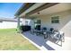 Covered patio with comfortable seating and sliding glass door access at 5531 Keaton Springs Dr, Lakeland, FL 33811