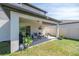 Covered patio featuring outdoor seating and well-maintained lawn at 5531 Keaton Springs Dr, Lakeland, FL 33811