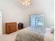 Serene bedroom featuring a bed with a floral comforter and a view of the screened in porch at 5639 Water Oak Ln, Mulberry, FL 33860