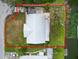 Aerial view of a property with a metal roof and canal access, outlined in red to show property lines at 5716 Gibson Shores Dr, Lakeland, FL 33809