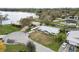 Aerial view of a single-Gathering home with a metal roof and lawn situated on a canal with lake access at 5716 Gibson Shores Dr, Lakeland, FL 33809