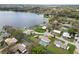 A scenic aerial view showcases residences along a lake and canal system with a variety of amenities at 5716 Gibson Shores Dr, Lakeland, FL 33809