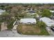 An aerial view of a single-Gathering home with a metal roof and lawn situated on a canal with lake access at 5716 Gibson Shores Dr, Lakeland, FL 33809