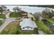 Aerial view of a waterfront home on a canal with access to a large lake, showcasing the metal roof at 5716 Gibson Shores Dr, Lakeland, FL 33809