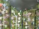 Aerial view showcases properties along a lake and canal system, featuring homes with waterfront access and docks at 5716 Gibson Shores Dr, Lakeland, FL 33809