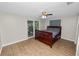 Bright bedroom with sliding doors to the screened porch and wood-look flooring at 5716 Gibson Shores Dr, Lakeland, FL 33809