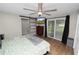 Well-lit bedroom featuring a large bed, barn door, and a sliding glass door to the outside at 5716 Gibson Shores Dr, Lakeland, FL 33809