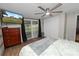 Cozy bedroom features a large bed, a television, and a sliding glass door to the outside at 5716 Gibson Shores Dr, Lakeland, FL 33809