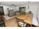 Open-concept dining room featuring a large wooden table, seating, and natural light from sliding glass doors at 5716 Gibson Shores Dr, Lakeland, FL 33809