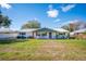 Charming single-story home featuring a metal roof, painted brick, and a welcoming front porch at 5716 Gibson Shores Dr, Lakeland, FL 33809
