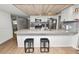Open kitchen with bar seating, stainless steel appliances, and a bright, inviting atmosphere at 5716 Gibson Shores Dr, Lakeland, FL 33809