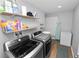 Clean laundry room with washer, dryer, storage shelves, and plenty of space at 5716 Gibson Shores Dr, Lakeland, FL 33809