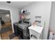 Laundry room with modern washer and dryer, utility sink, and shelving for storage at 5716 Gibson Shores Dr, Lakeland, FL 33809