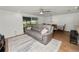 Open-concept space features living room with a leather sofa, a television, and dining room at 5716 Gibson Shores Dr, Lakeland, FL 33809