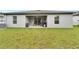 Large, grassy backyard with a covered patio at 6296 Dolostone Dr, Lakeland, FL 33811