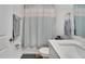 Bathroom with a shower featuring a unique shower curtain, toilet and a vanity with quartz countertop at 6296 Dolostone Dr, Lakeland, FL 33811