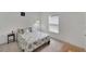 Bright bedroom with a patterned bedspread, side table and a large window at 6296 Dolostone Dr, Lakeland, FL 33811