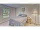A bedroom featuring a bed, a window, a lamp, and a nightstand at 6296 Dolostone Dr, Lakeland, FL 33811