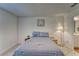 A bedroom featuring a bed, a window, a lamp, and a nightstand at 6296 Dolostone Dr, Lakeland, FL 33811