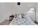 Bright bedroom with a patterned bedspread, side table and a large window at 6296 Dolostone Dr, Lakeland, FL 33811
