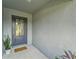 Inviting front porch with a modern door and decorative welcome sign at 6296 Dolostone Dr, Lakeland, FL 33811