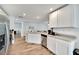 Kitchen featuring granite countertops, white cabinets, stainless steel appliances, and wood-look flooring at 6296 Dolostone Dr, Lakeland, FL 33811