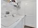 Well-equipped laundry room with washer, dryer, and storage shelves at 6296 Dolostone Dr, Lakeland, FL 33811