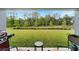 Relaxing outdoor patio with green grass, lake, and treeline views at 6296 Dolostone Dr, Lakeland, FL 33811