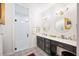 Bathroom features a walk-in shower, dual sinks, vanity, decorative tile, and modern lighting at 631 W Park St, Lakeland, FL 33803