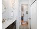 Bathroom with elegant tile flooring leads to a hallway and shower at 631 W Park St, Lakeland, FL 33803