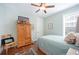 Bedroom with a ceiling fan, wooden floors, and a wardrobe at 631 W Park St, Lakeland, FL 33803