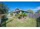 Landscaped yard of blue home with white pillars supporting the front porch at 631 W Park St, Lakeland, FL 33803