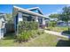 Blue home featuring a welcoming front porch with elegant white pillars at 631 W Park St, Lakeland, FL 33803