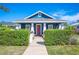 Charming blue house with a vibrant red door and well-maintained landscaping at 631 W Park St, Lakeland, FL 33803