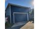 Spacious detached garage with blue siding and ample parking space at 631 W Park St, Lakeland, FL 33803